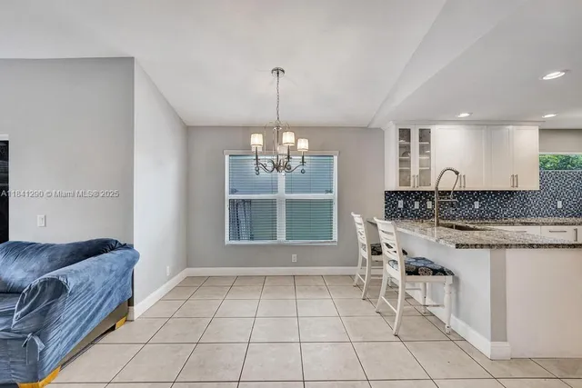 a view of a livingroom with a chandelier furniture and windows