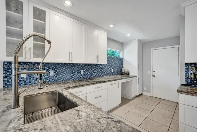 a kitchen with a sink cabinets and appliances