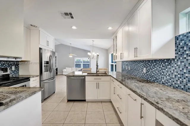 a kitchen with a sink stove and refrigerator
