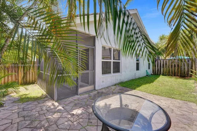 a view of a chair with a house in the back yard