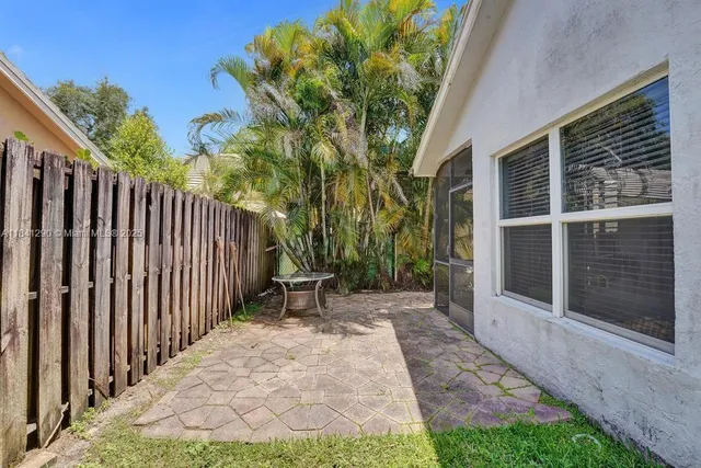 a view of a backyard with pathway