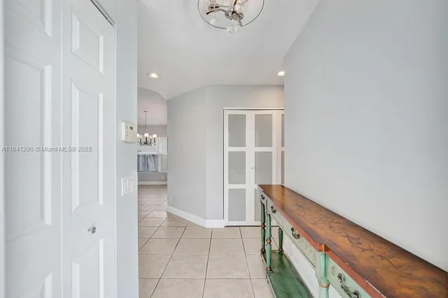 a view of an entryway with wooden floor and cabinet