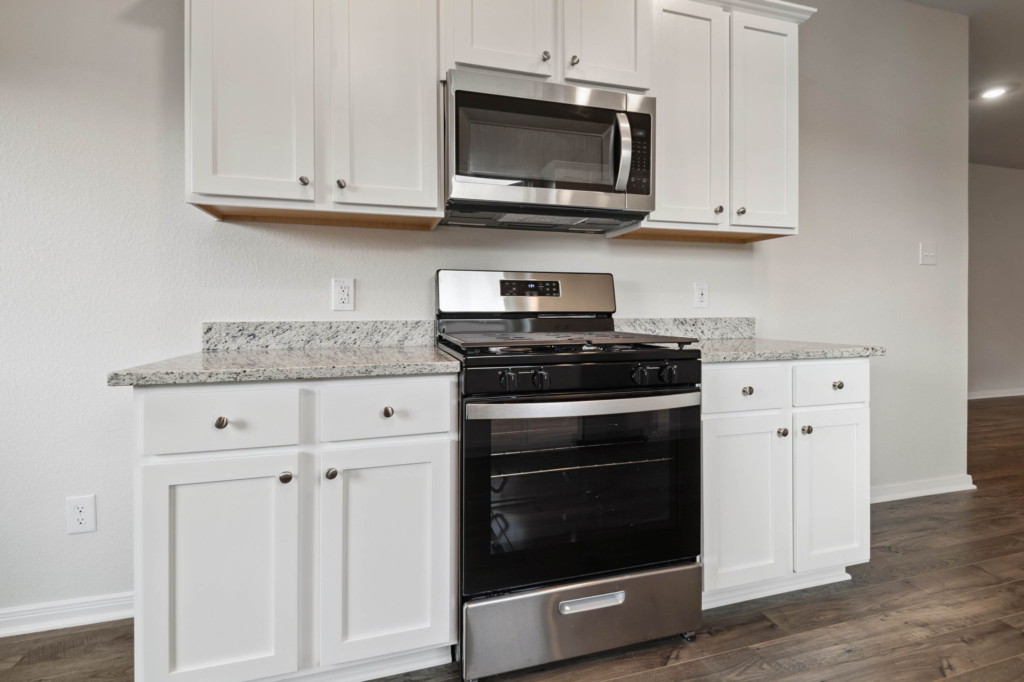15434 Maple Ter Drive Conroe, TX 77303 - Photo 8 of 25 a kitchen with stainless steel appliances granite countertop white cabinets granite counter tops and a wooden floors