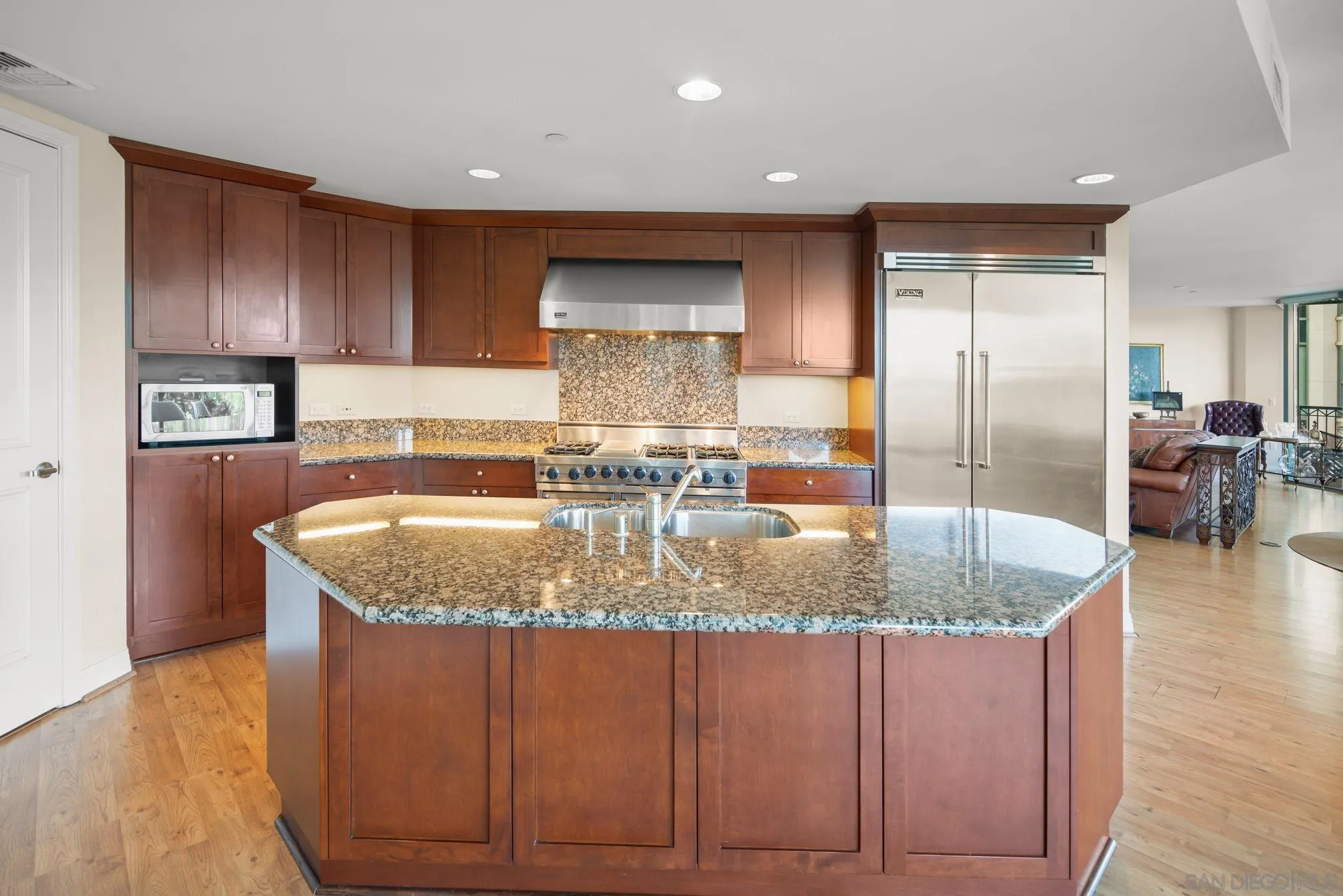 2500 Sixth Avenue, Unit 605 San Diego, CA 92103 - Photo 14 of 29 a kitchen with kitchen island granite countertop a sink a counter top space and cabinets