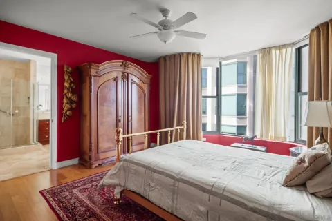 a bedroom with a bed dresser and a window