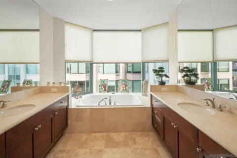 a large bathroom with a large tub and sink