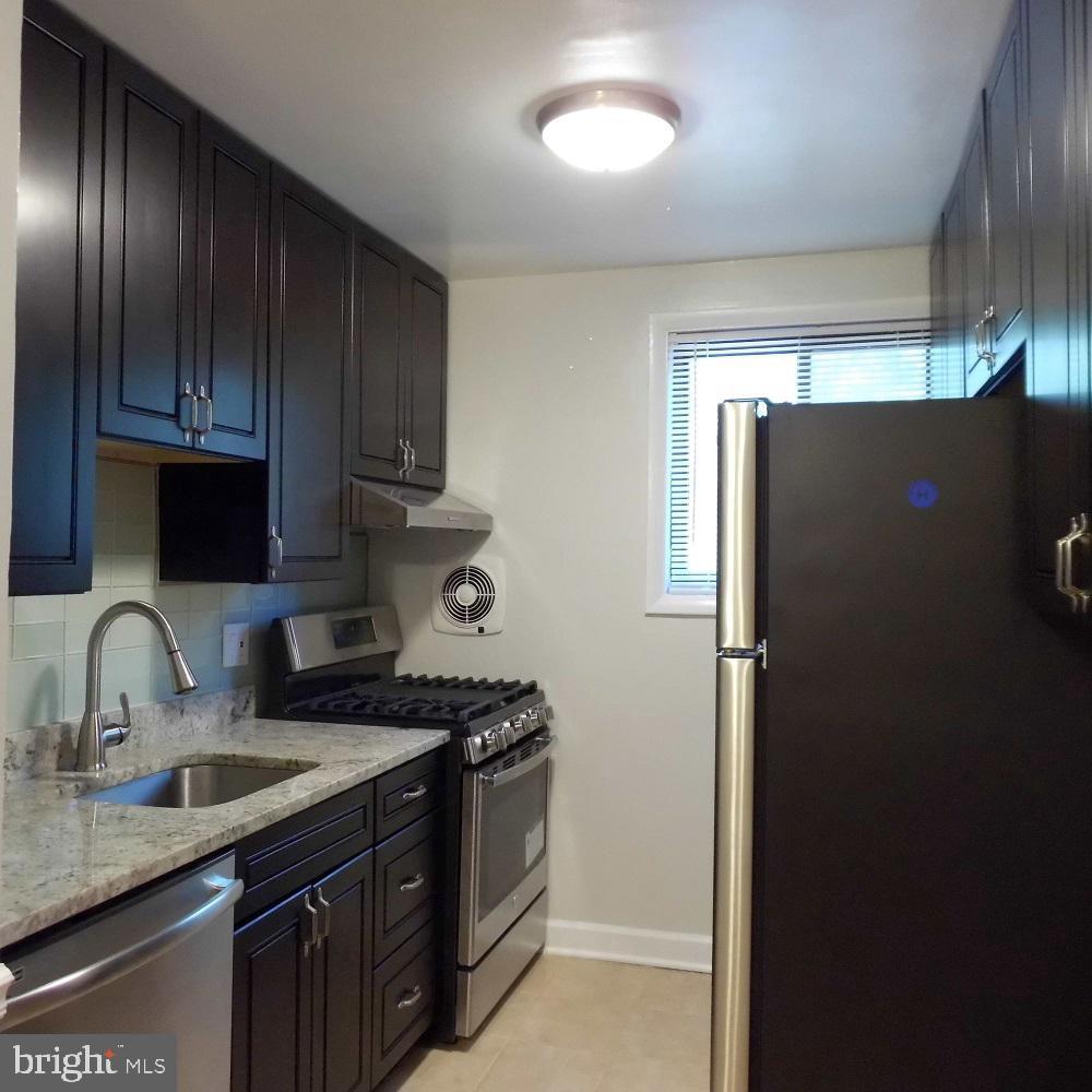 2848 Annandale Road, Unit 124 Falls Church, VA 22042 - Photo 4 of 8 a kitchen with a refrigerator and a sink