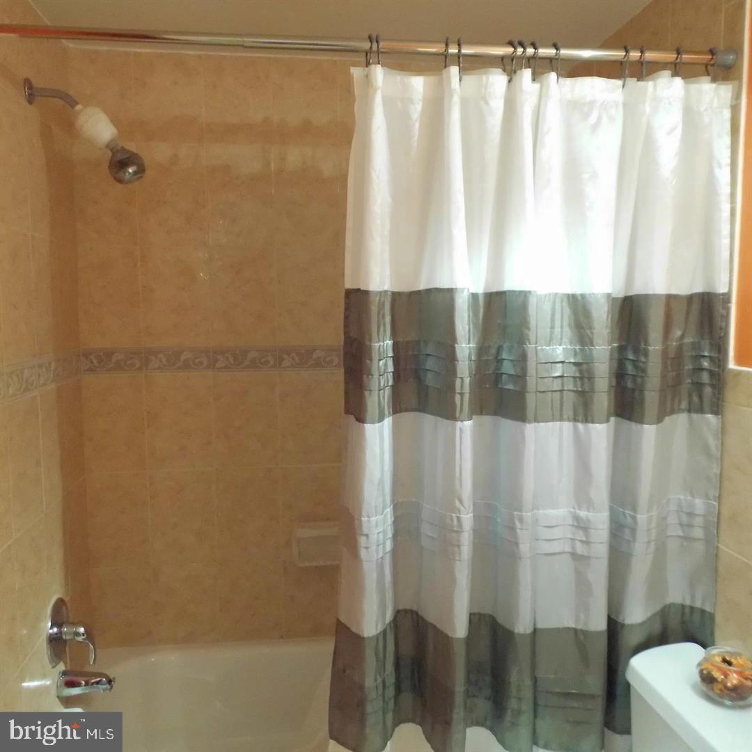 2848 Annandale Road, Unit 124 Falls Church, VA 22042 - Photo 7 of 8 a bathroom with a shower curtain