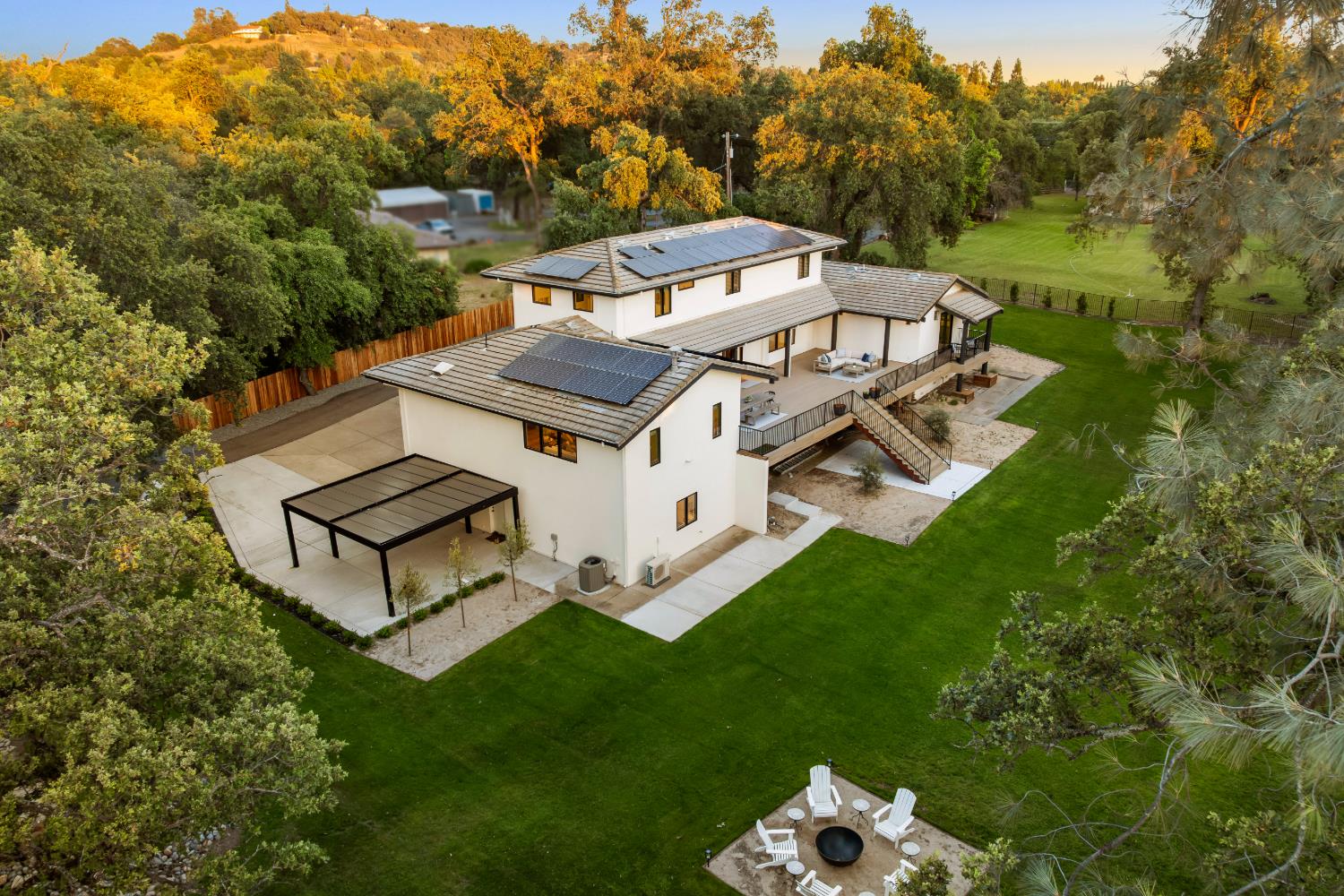 7697 Horseshoe Bar Road Loomis, CA 95650 - Photo 69 of 76 a view of a white house with a big yard and large trees