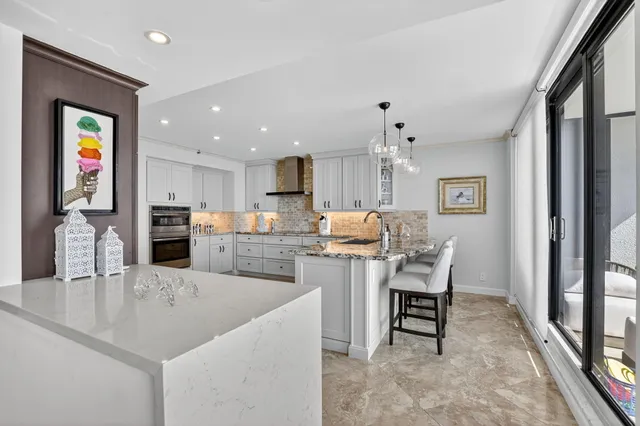 a bedroom with a large bed and a chandelier