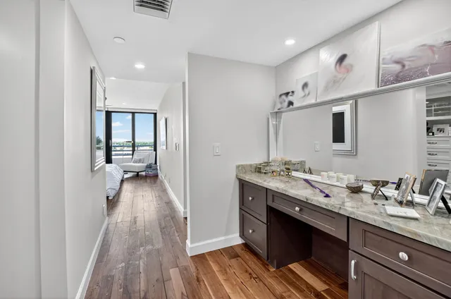 a living room with furniture flat screen tv and floor to ceiling window