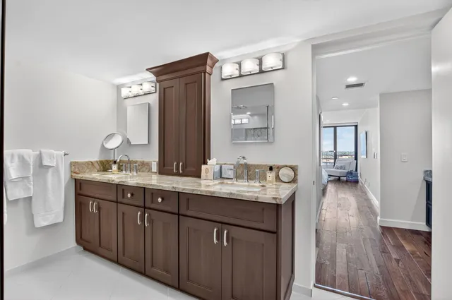 a bedroom with two beds and wooden floor