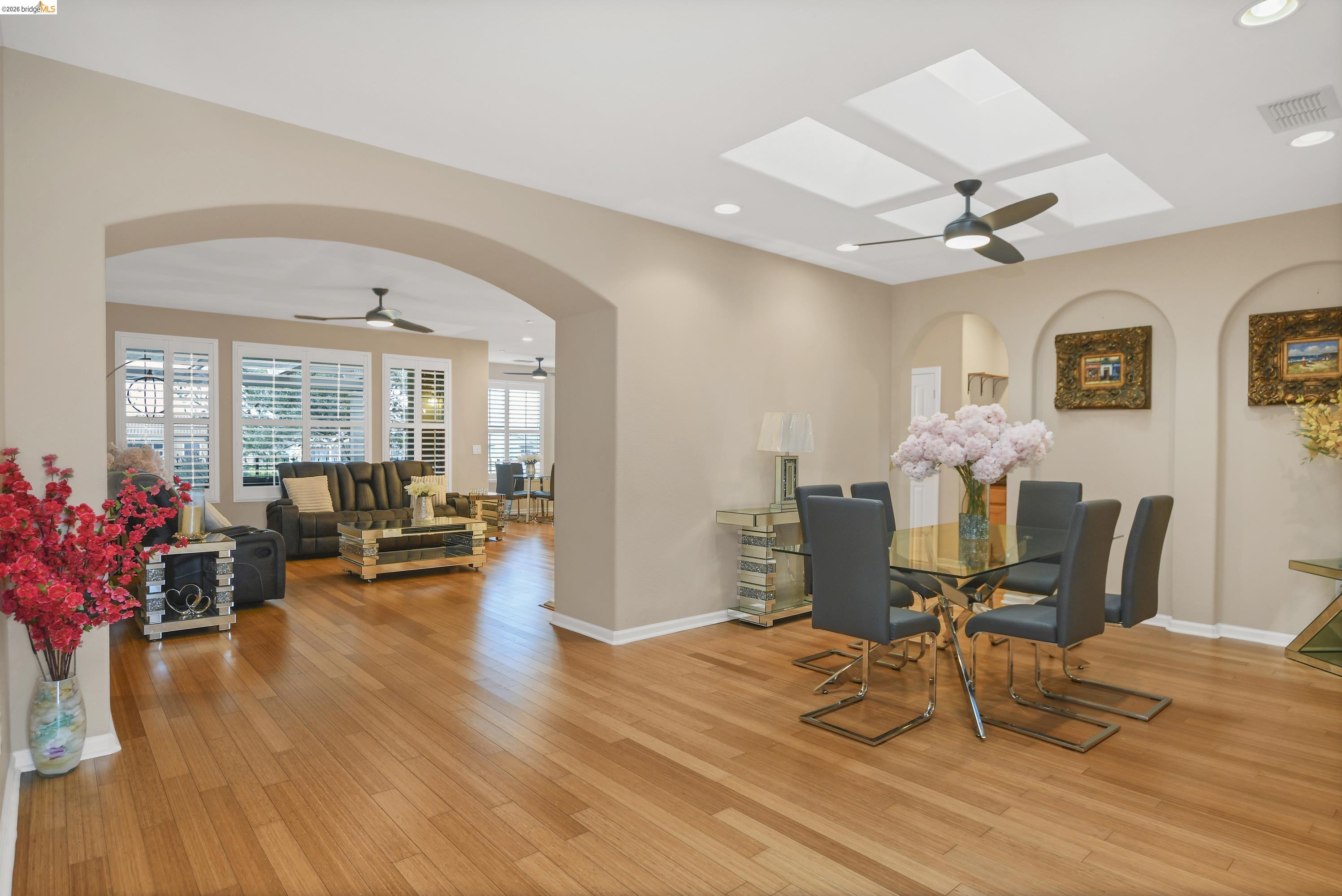342 Desert Forest Court Rio Vista, CA 94571 - Photo 18 of 40 Dining area with ceiling fan, arched walkways, recessed lighting, light wood-style flooring, and a wood stove