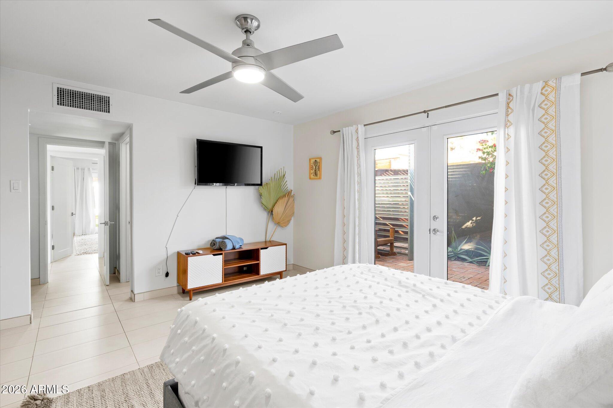 3812 East Coronado Road Phoenix, AZ 85008 - Photo 14 of 46 a bedroom with a bed and a flat screen tv