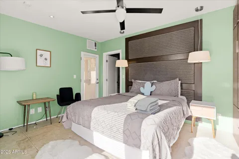 a spacious bedroom with a large bed and a window