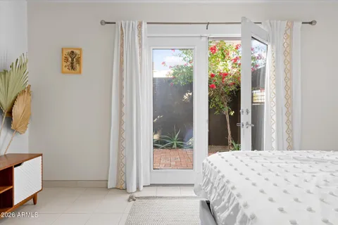 a bedroom with a bed and a chair