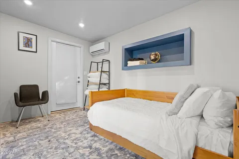 a spacious bedroom with a bed and a mirror