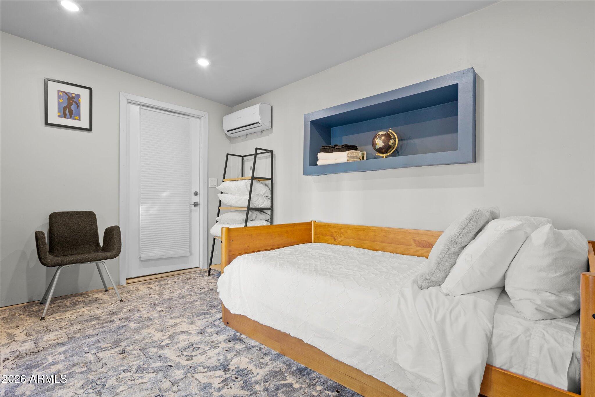 3812 East Coronado Road Phoenix, AZ 85008 - Photo 21 of 46 a bedroom with a bed and a chair