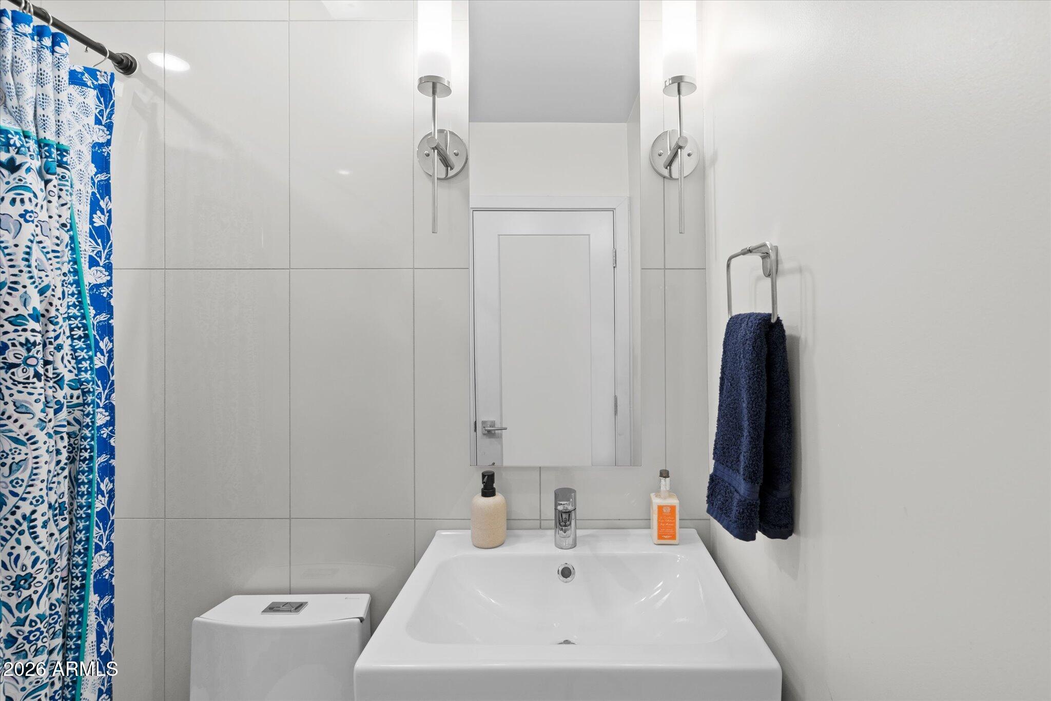 3812 East Coronado Road Phoenix, AZ 85008 - Photo 25 of 46 a bathroom with a sink a toilet and shower