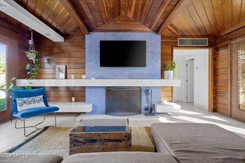 a living room with furniture and a floor to ceiling window