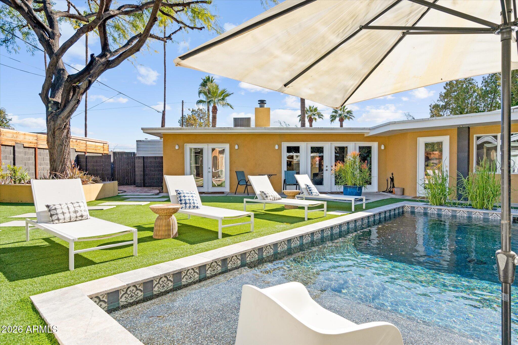 3812 East Coronado Road Phoenix, AZ 85008 - Photo 34 of 46 a view of a house with swimming pool and a porch