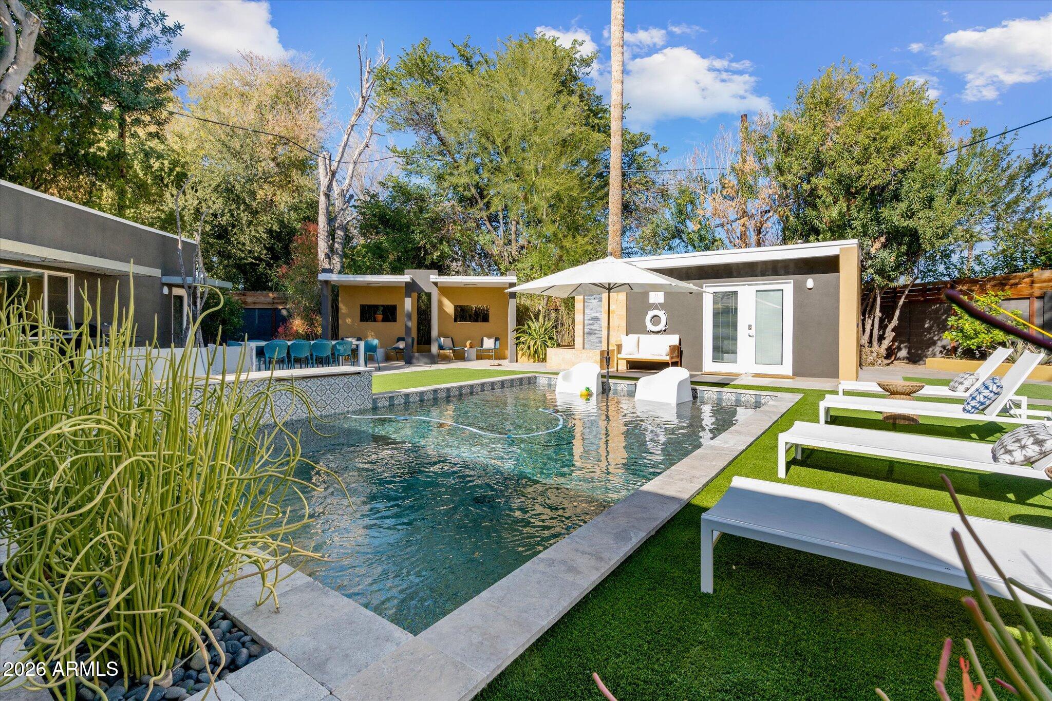 3812 East Coronado Road Phoenix, AZ 85008 - Photo 35 of 46 swimming pool view with a seating space and a garden view