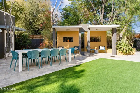 a swimming pool with outdoor seating and yard