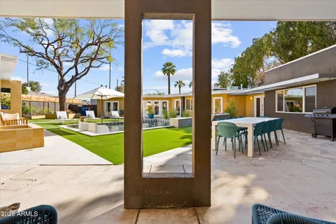 a view of a patio with couches table and chairs and garden