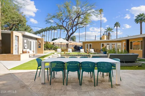a view of a house with a yard patio and swimming pool
