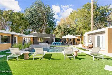 a view of a patio with table and chairs and potted plants