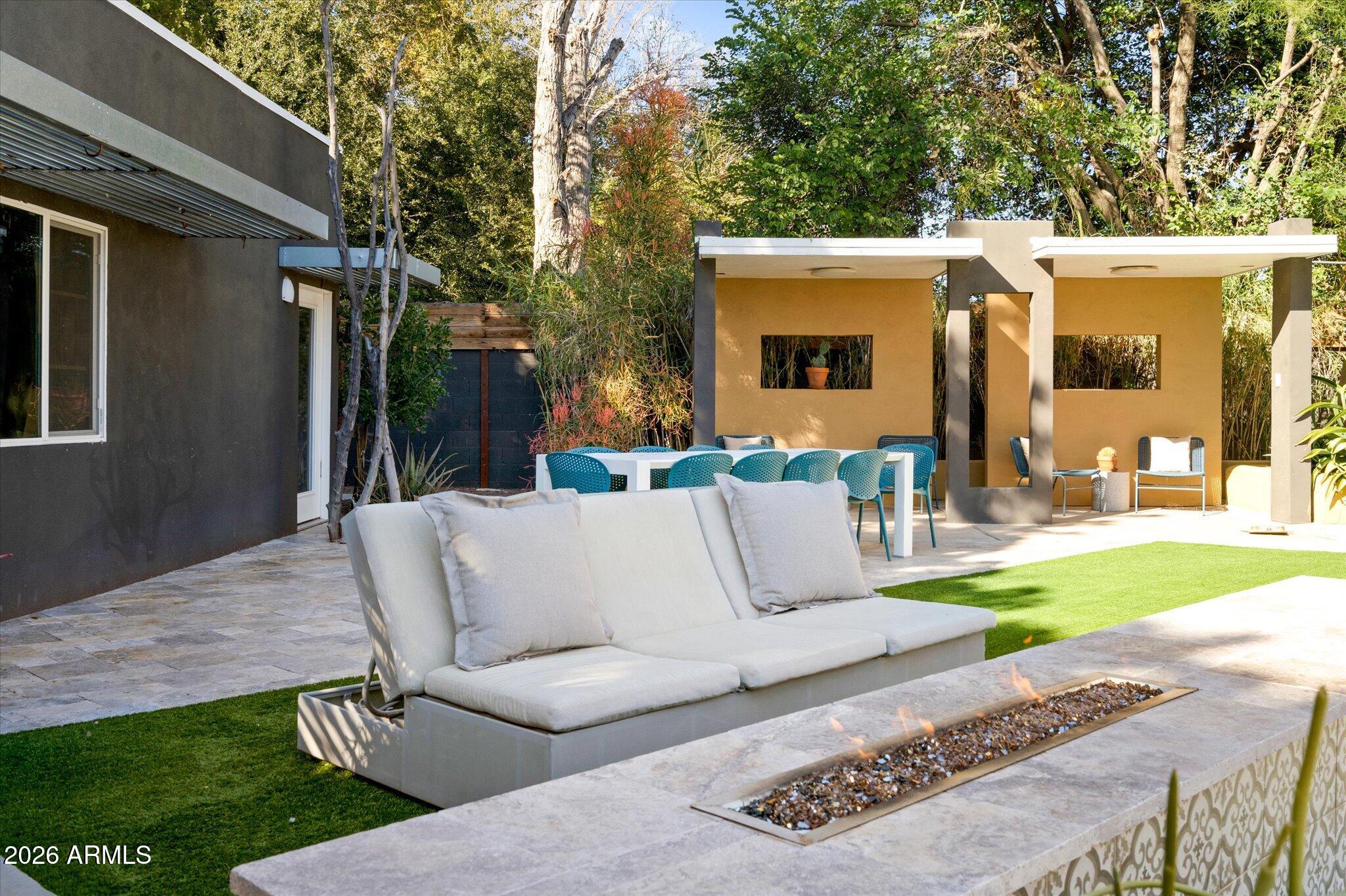 3812 East Coronado Road Phoenix, AZ 85008 - Photo 40 of 46 a view of a patio with couches table and chairs and garden