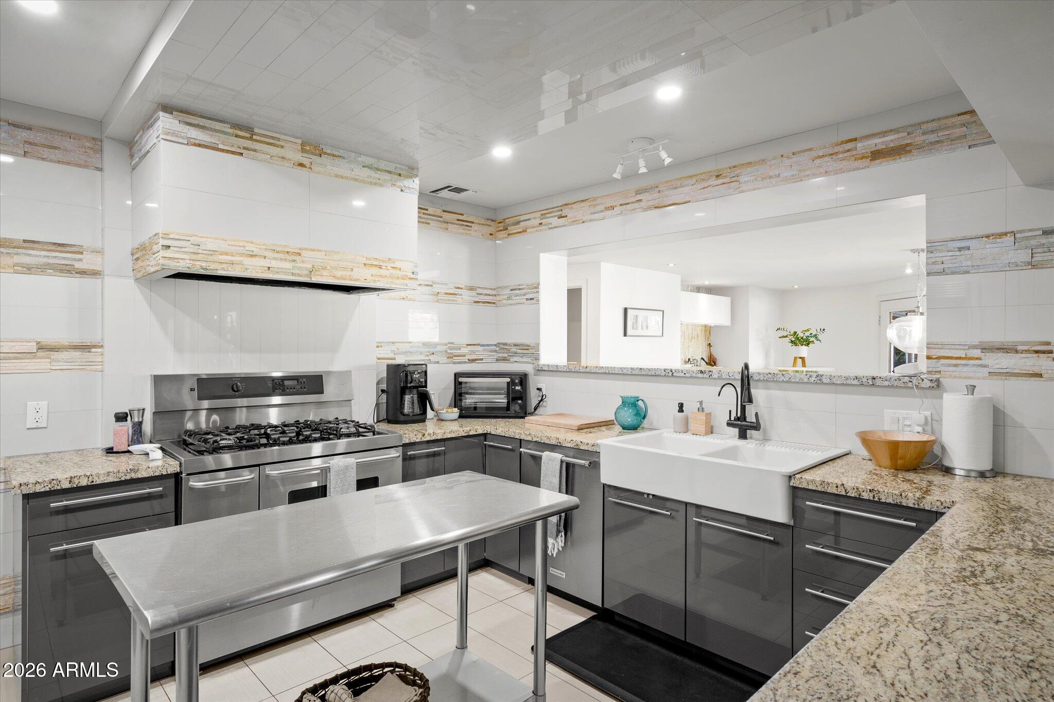 3812 East Coronado Road Phoenix, AZ 85008 - Photo 6 of 46 a kitchen with a stove a sink and a refrigerator