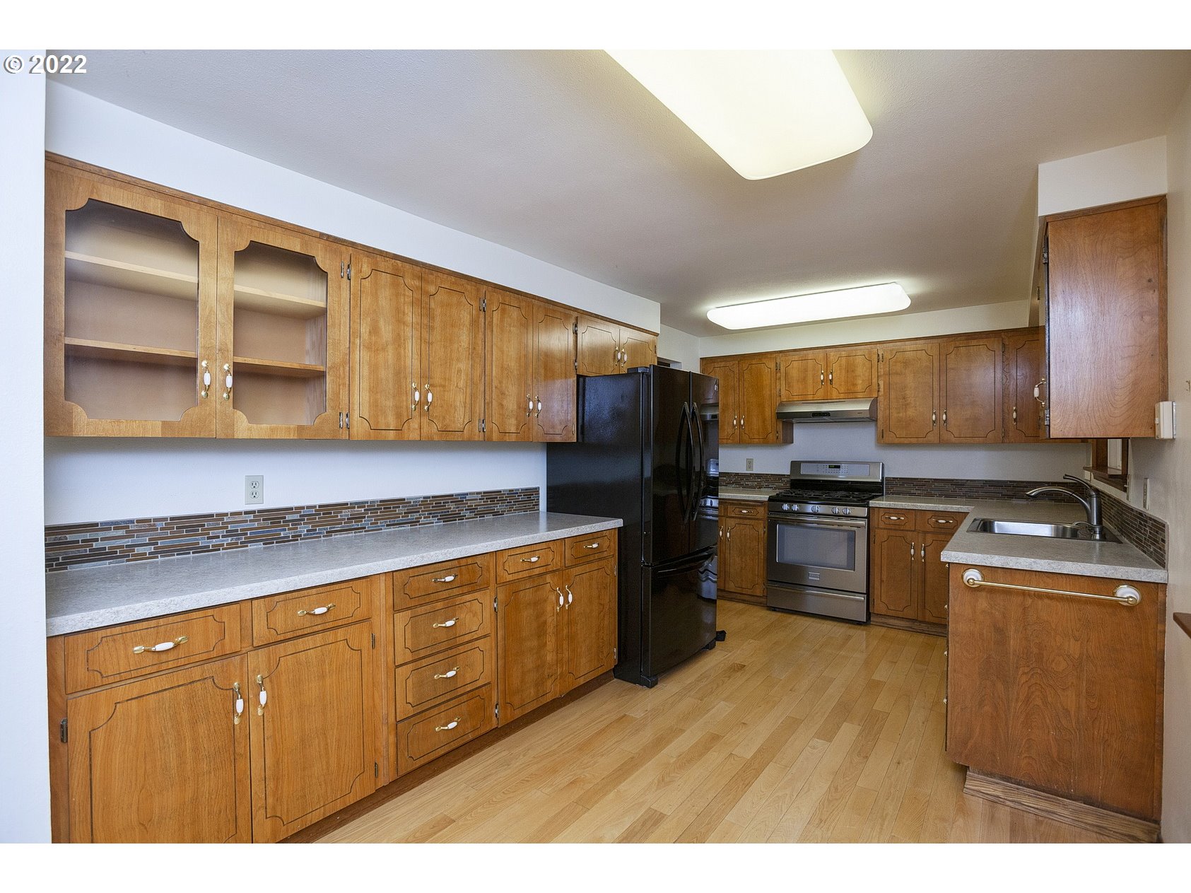 16190 South Wilson Road Oregon City, OR 97045 - Photo 11 of 32 a kitchen with stainless steel appliances granite countertop a stove a sink dishwasher and a refrigerator