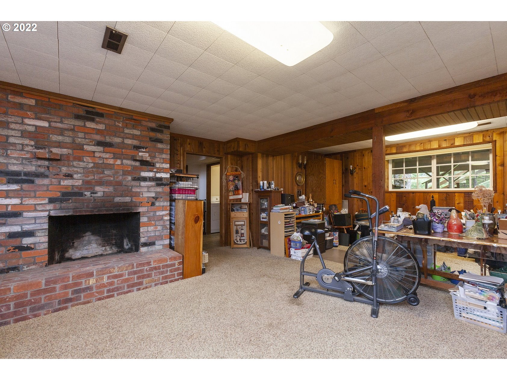 16190 South Wilson Road Oregon City, OR 97045 - Photo 25 of 32 a living room with furniture a flat screen tv and a fireplace