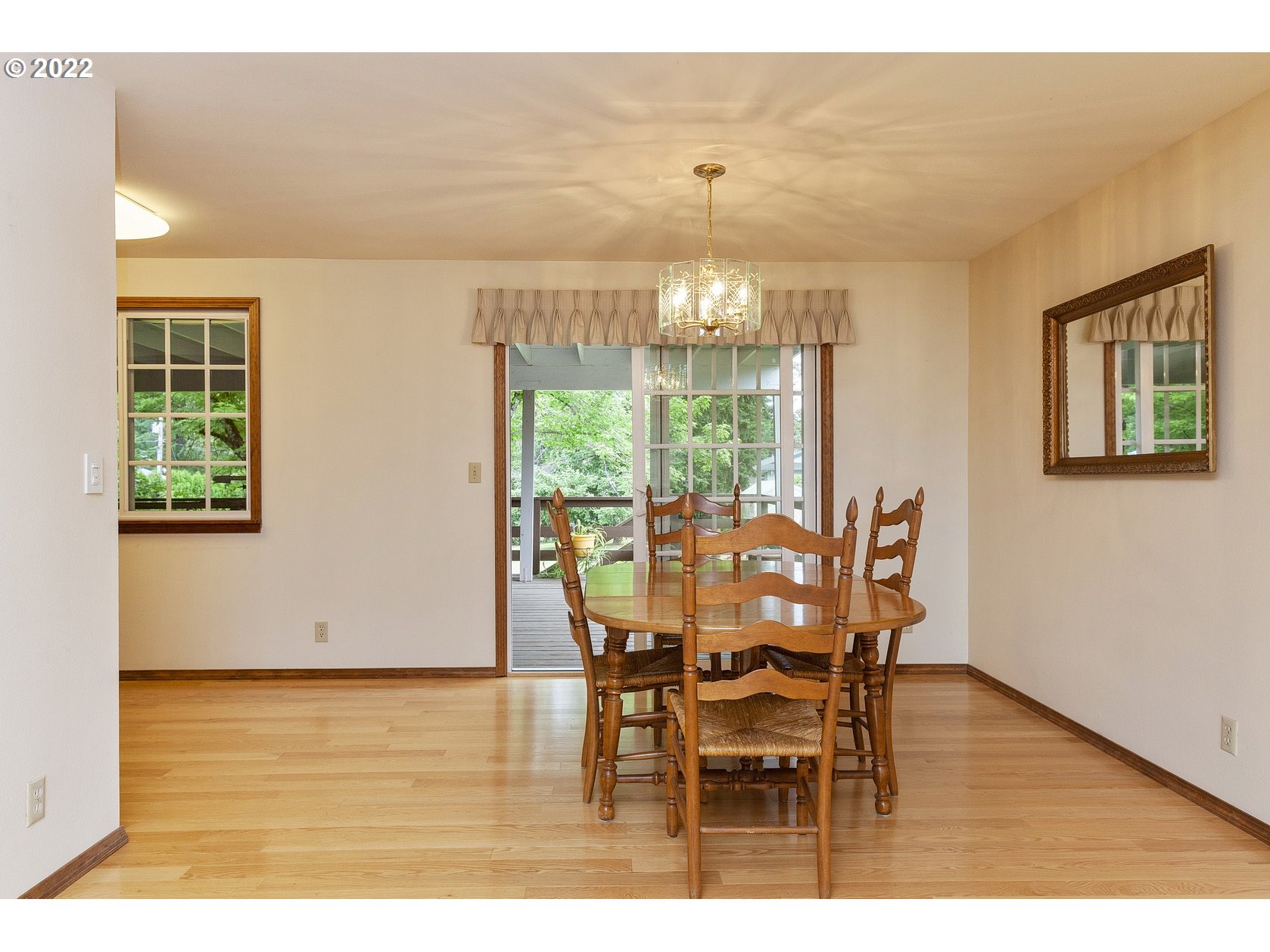 16190 South Wilson Road Oregon City, OR 97045 - Photo 9 of 32 a view of a dining room with furniture and wooden floor