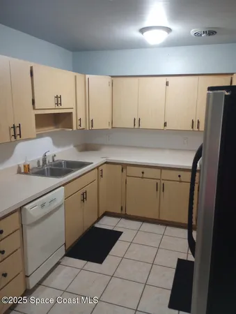 a kitchen with a stove refrigerator and sink