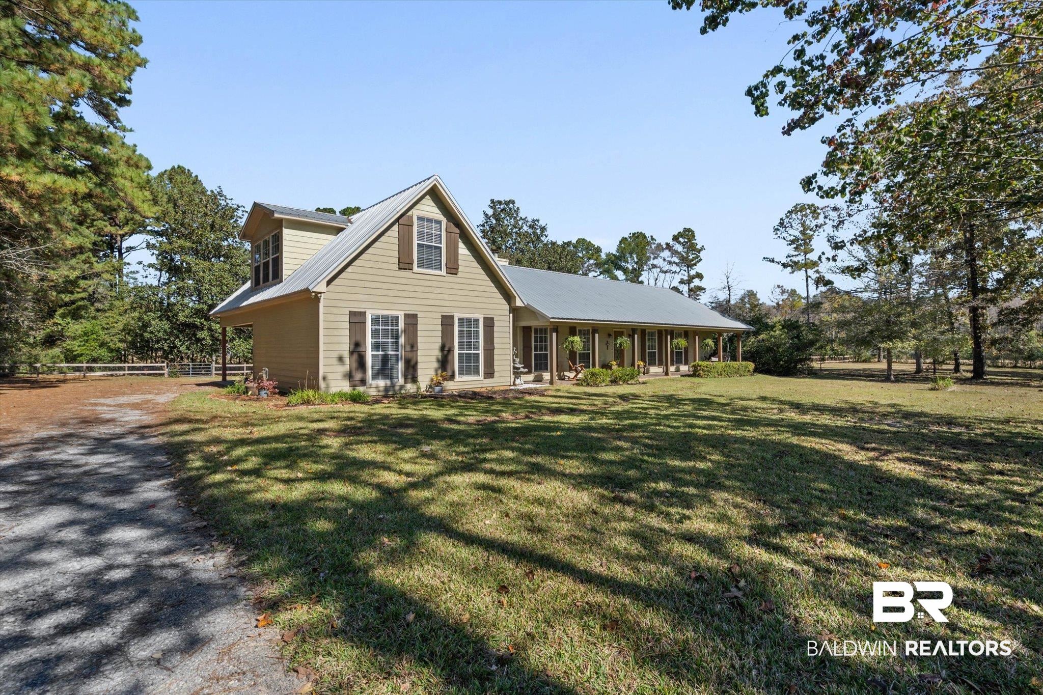 180 Creax Road Axis, AL 36505 - Photo 31 of 35 View of front of house with a metal roof and a porch