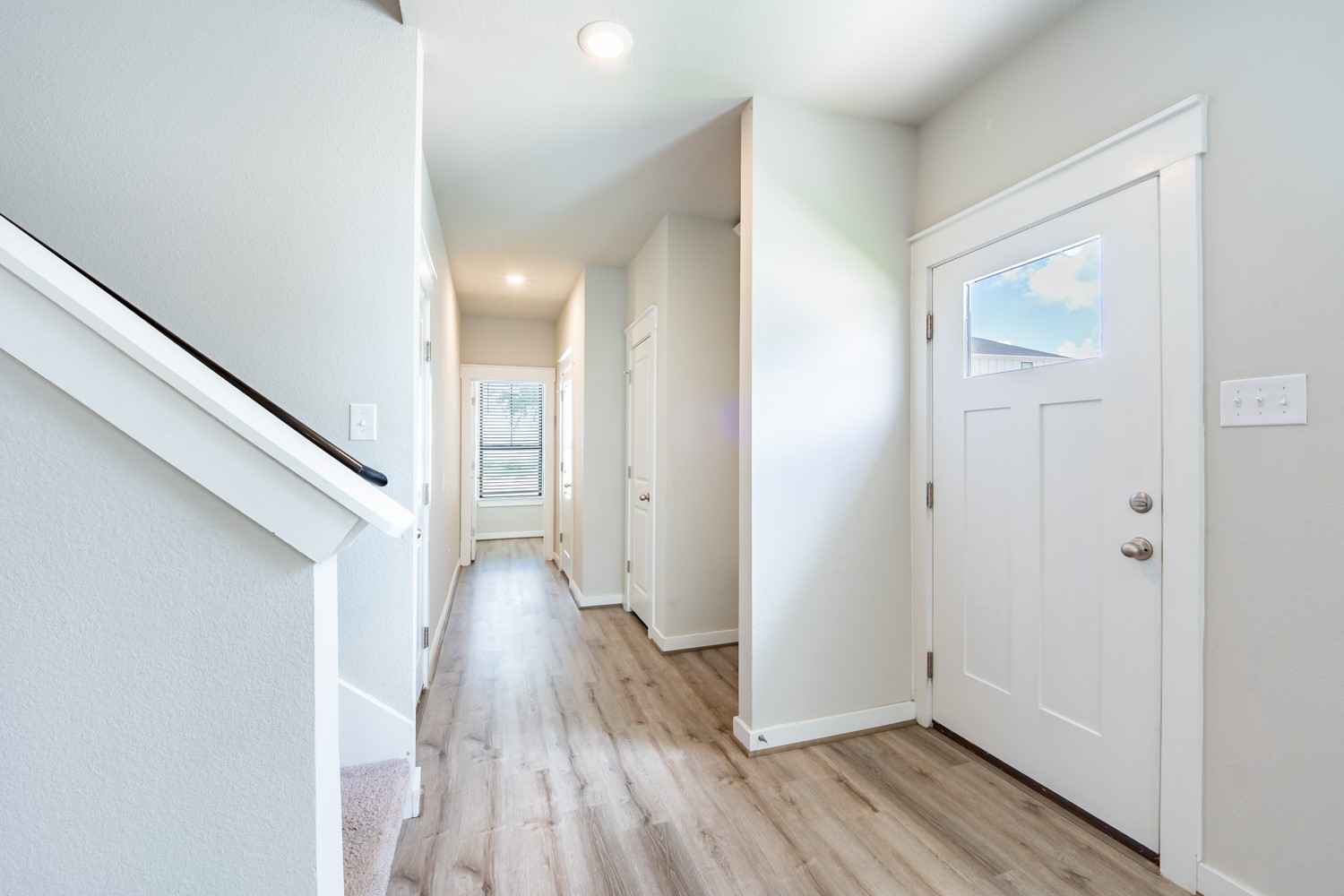 147 Waterside Road, Unit A Buda, TX 78610 - Photo 5 of 27 A well-lit entry hall with durable plank flooring welcomes residents and guests.
