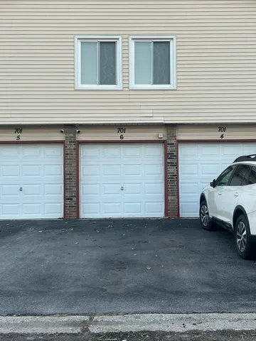 a car parked in front of a white house