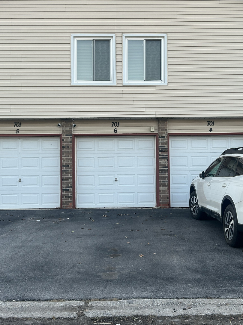 701 Spring Court, Unit 6 University Park, IL 60484 - Photo 6 of 6 a car parked in front of a white house