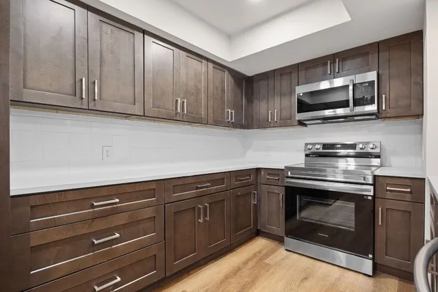 a kitchen with granite countertop cabinets and refrigerator