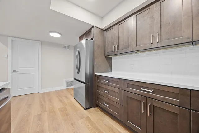 a view of a refrigerator in kitchen and wooden floor