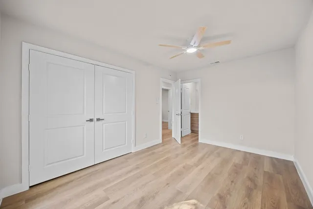 a bathroom with a granite countertop toilet sink and a mirror