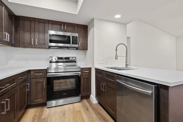 a kitchen with a sink and a refrigerator