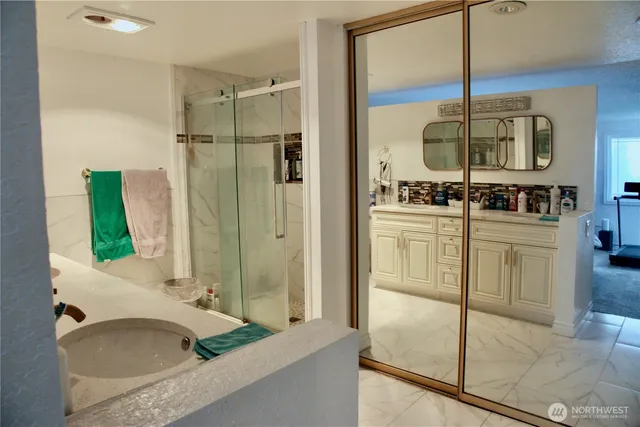 a bathroom with a tub sink and mirror