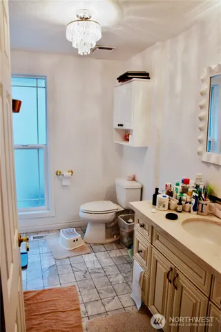 a bathroom with a sink mirror and toilet