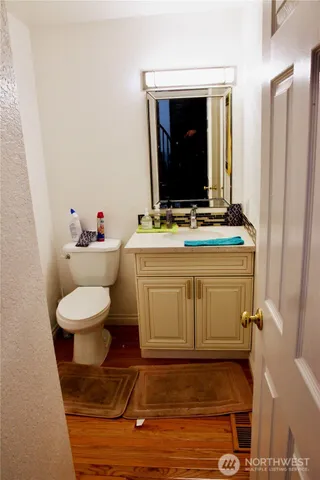 a bathroom with a sink toilet and mirror