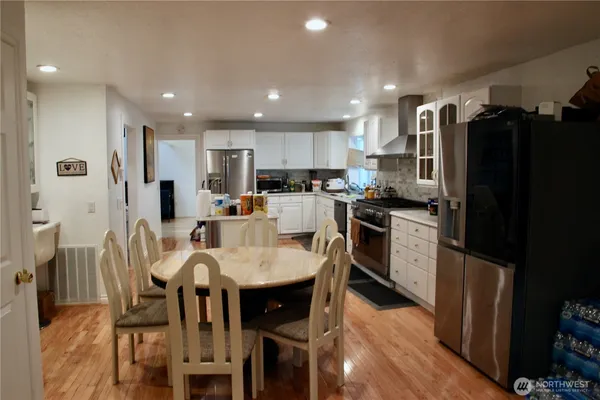 a large kitchen with a table and chairs