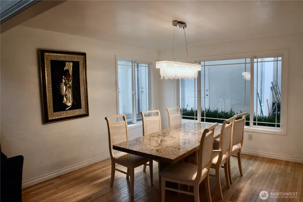 a view of a dining room with furniture and wooden floor