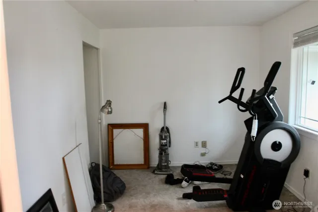 a room with gym equipment and windows